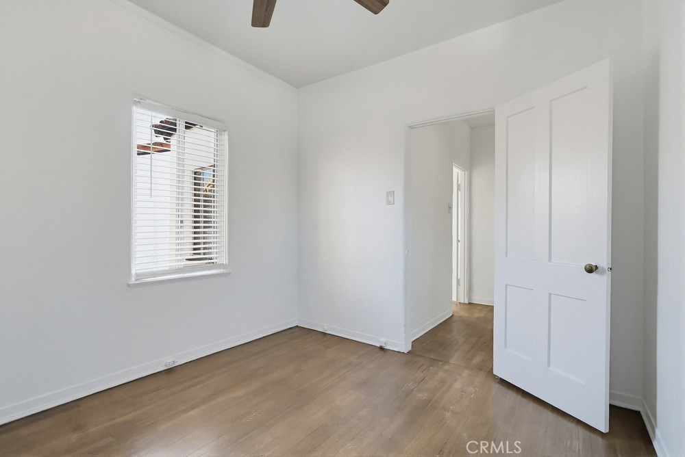 1527 East 3rd Street, Unit 1531 Long Beach, CA 90802 - Photo 28 of 38 a view of an empty room with wooden floor and a window