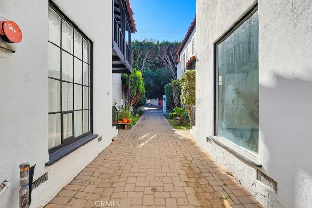 a view of a pathway both side of the house