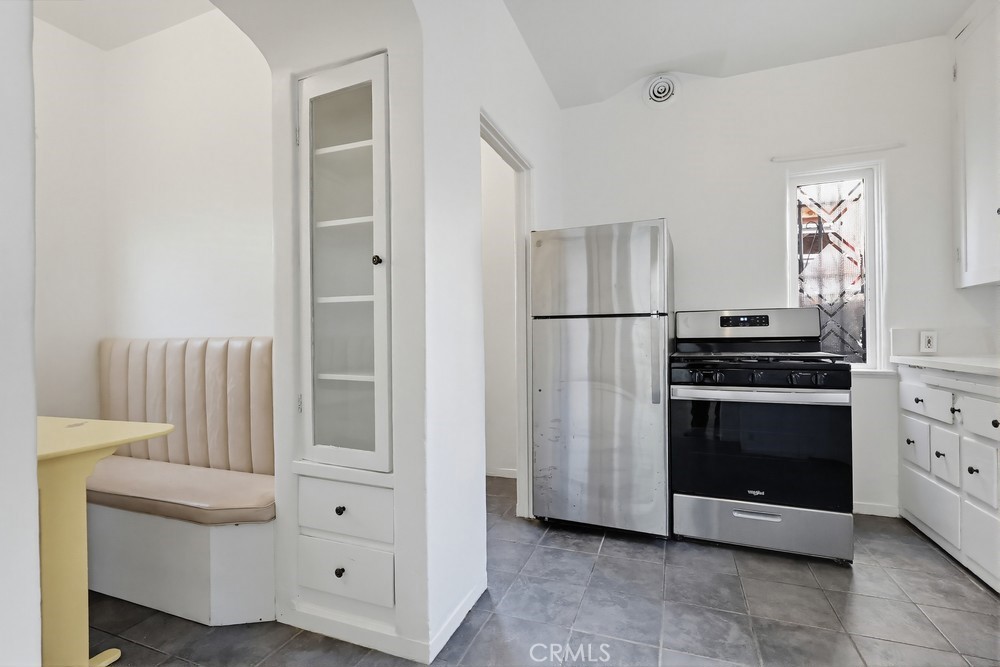 1527 East 3rd Street, Unit 1531 Long Beach, CA 90802 - Photo 8 of 38 a kitchen with cabinets and stainless steel appliances