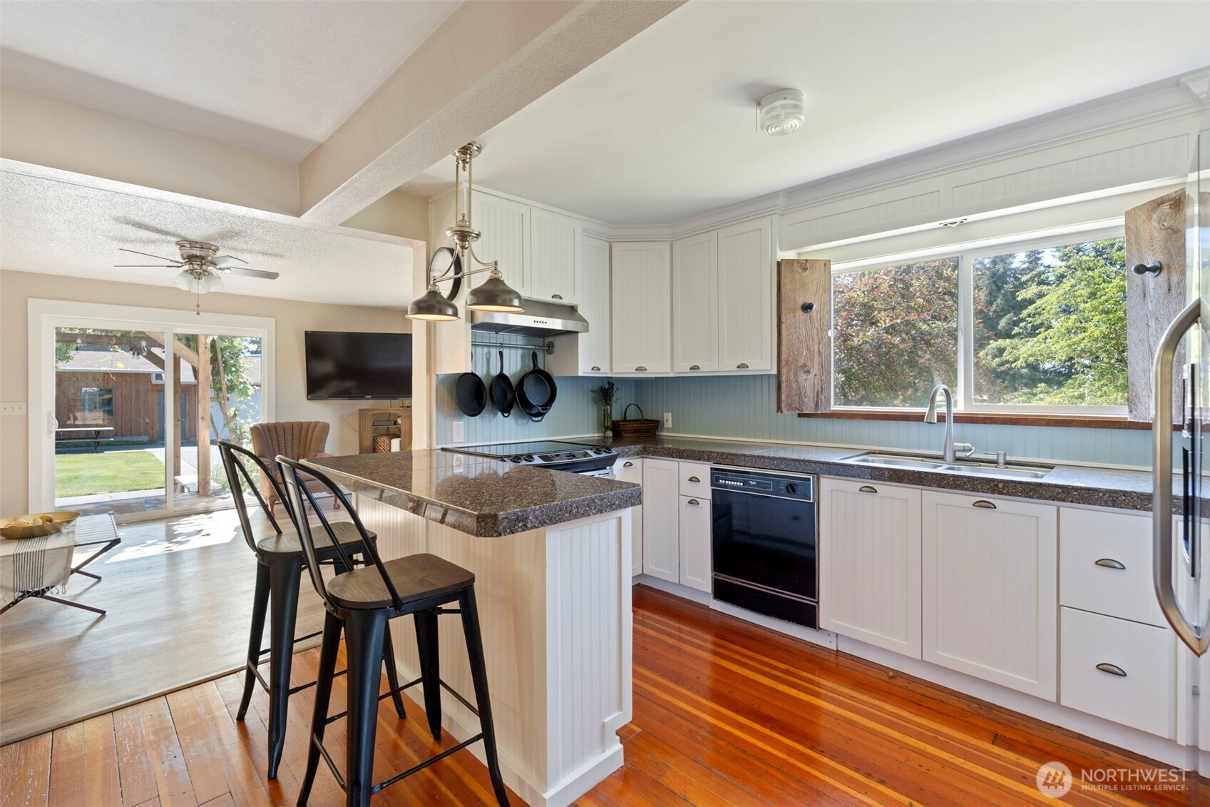 2118 Gallagher Road Centralia, WA 98531 - Photo 10 of 40 a kitchen with stainless steel appliances granite countertop a stove top oven a sink dishwasher a dining table and chairs with wooden floor