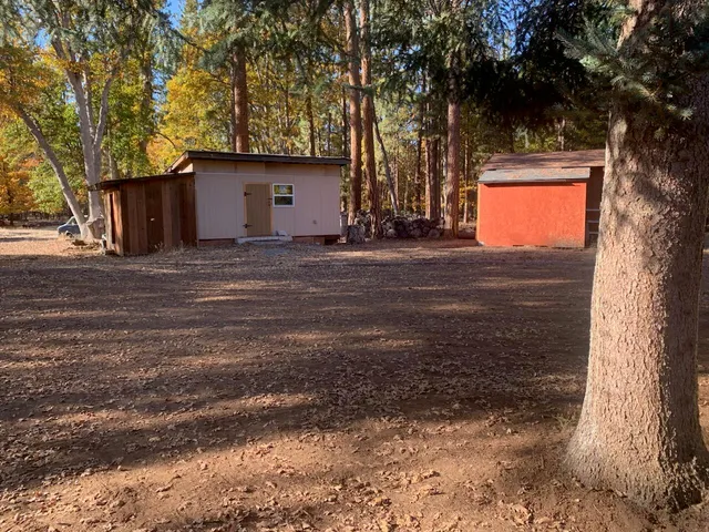 a kitchen with a table chairs refrigerator and cabinets