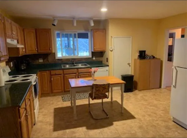 a house that has a tree in front of it