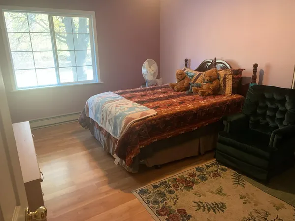 a bed sitting in a room next to a fireplace