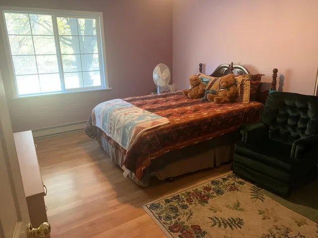 a bed sitting in a room next to a fireplace