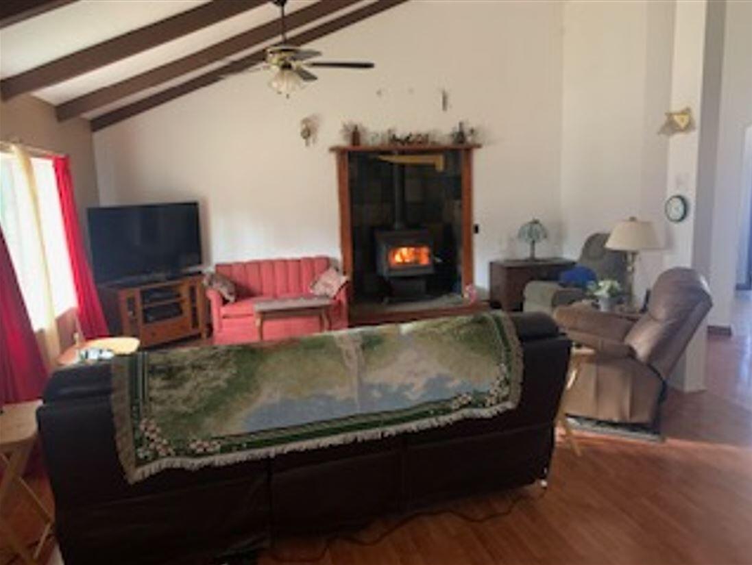 41077 Last Chance Lane Fall River Mills, CA 96028 - Photo 21 of 42 a bed sitting in a room next to a fireplace