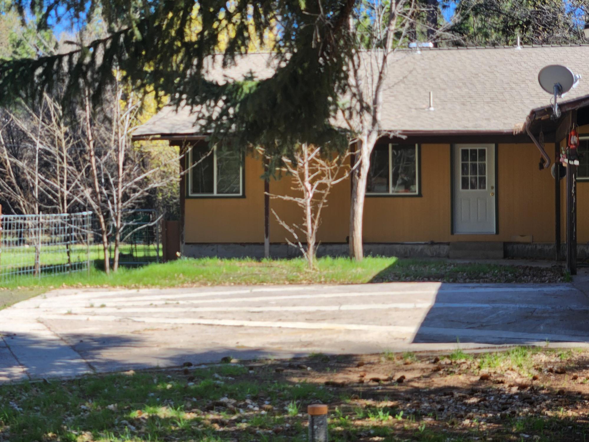 41077 Last Chance Lane Fall River Mills, CA 96028 - Photo 22 of 42 a front view of a house with a yard and garage