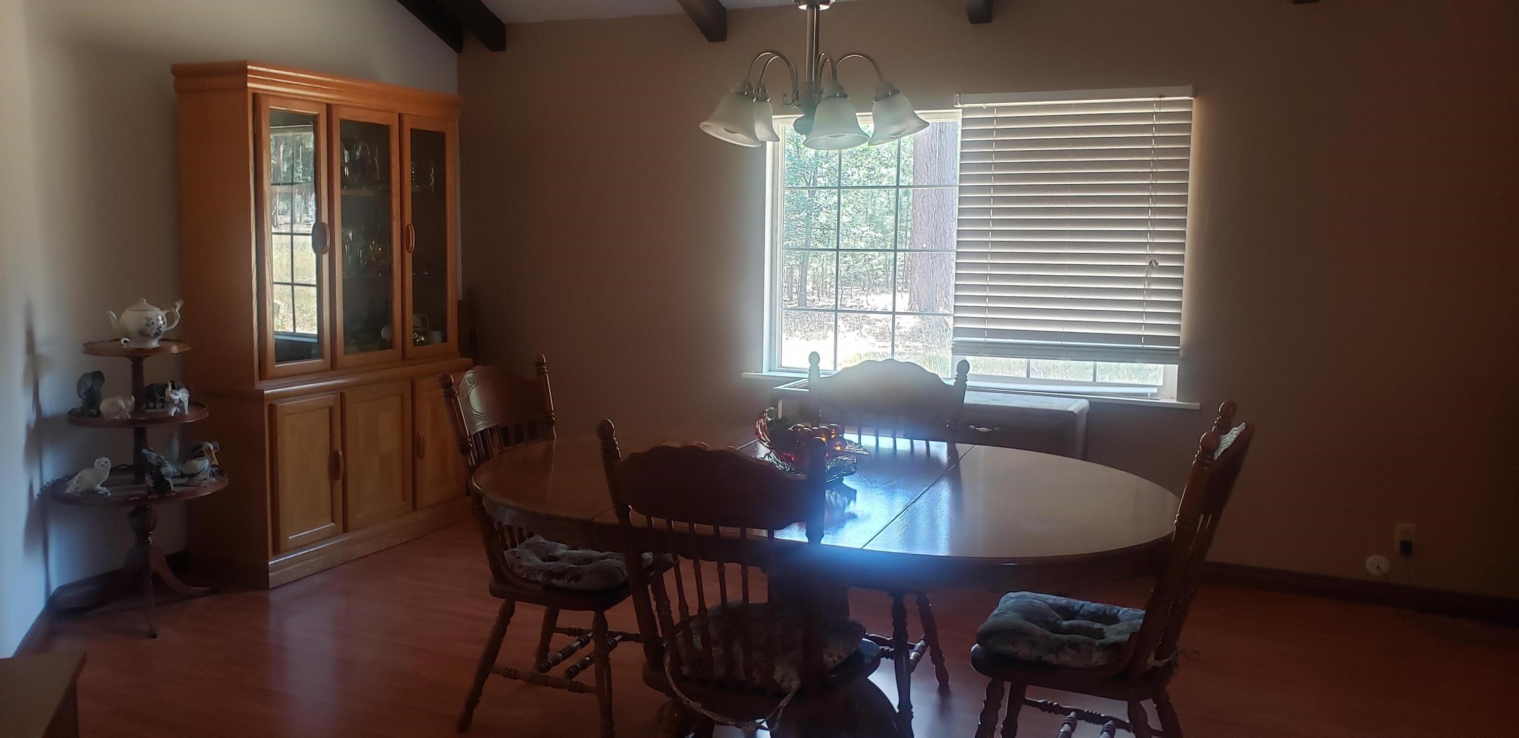 41077 Last Chance Lane Fall River Mills, CA 96028 - Photo 3 of 42 a view of a dining room with furniture and chandelier