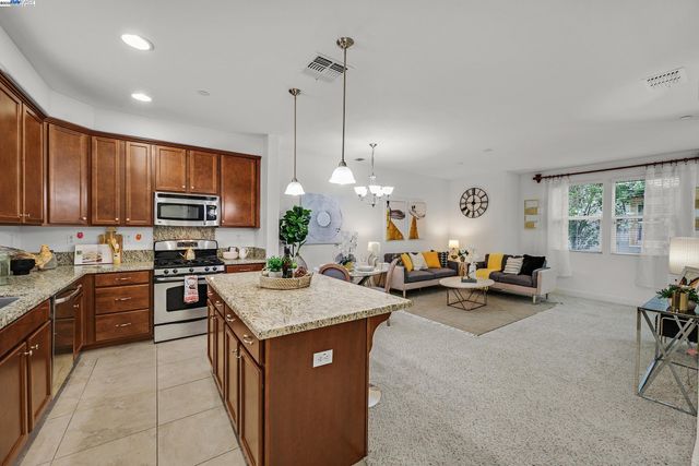 a kitchen with sink refrigerator and microwave
