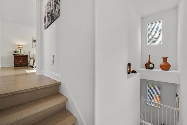 a bedroom with a large bed and a painting on the wall