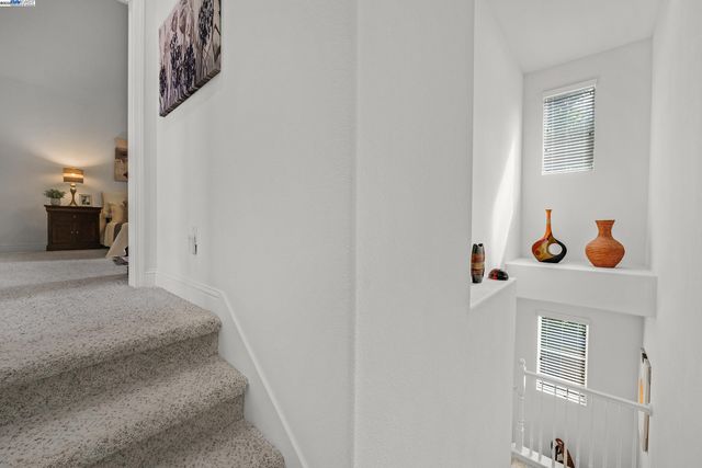 a view of a hallway to rooms and a fireplace