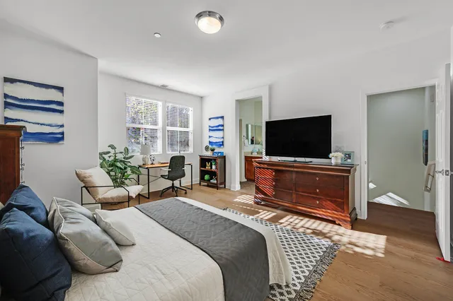 a view of a hallway with wooden floor and entryway