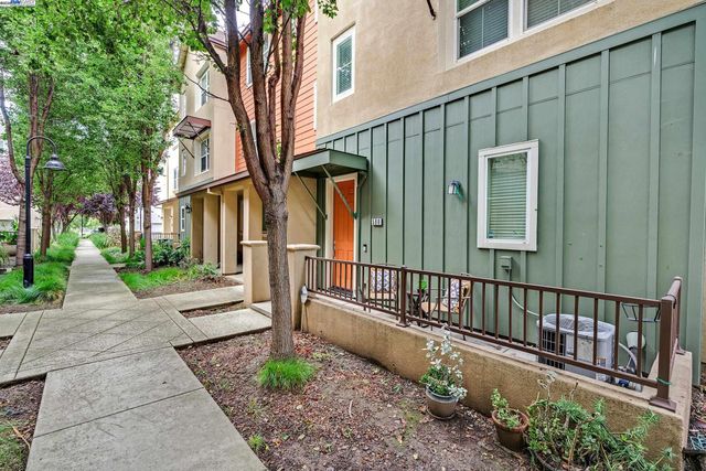a view of a house with a small yard and floor to ceiling window