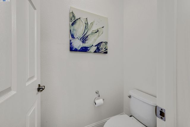 a bathroom with a painting on the wall and a shower