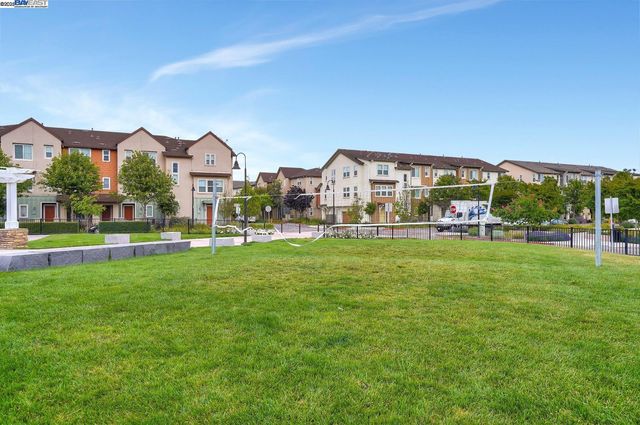 a view of a big house with a big yard and large trees