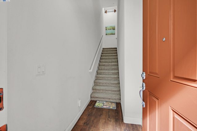 a view of a hallway with wooden floor and entryway