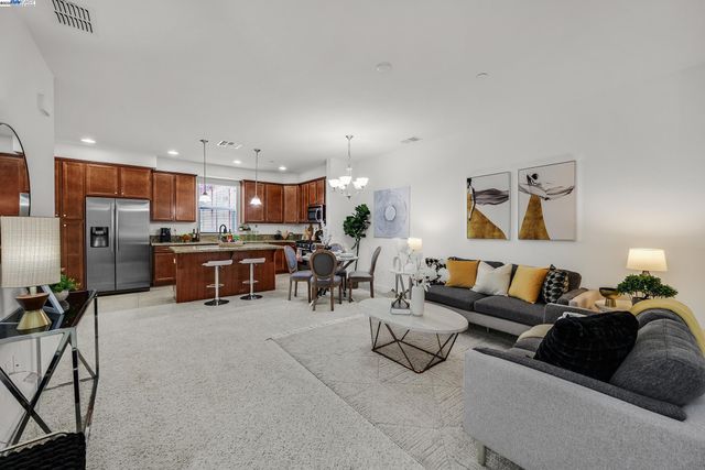 a living room with furniture and kitchen view