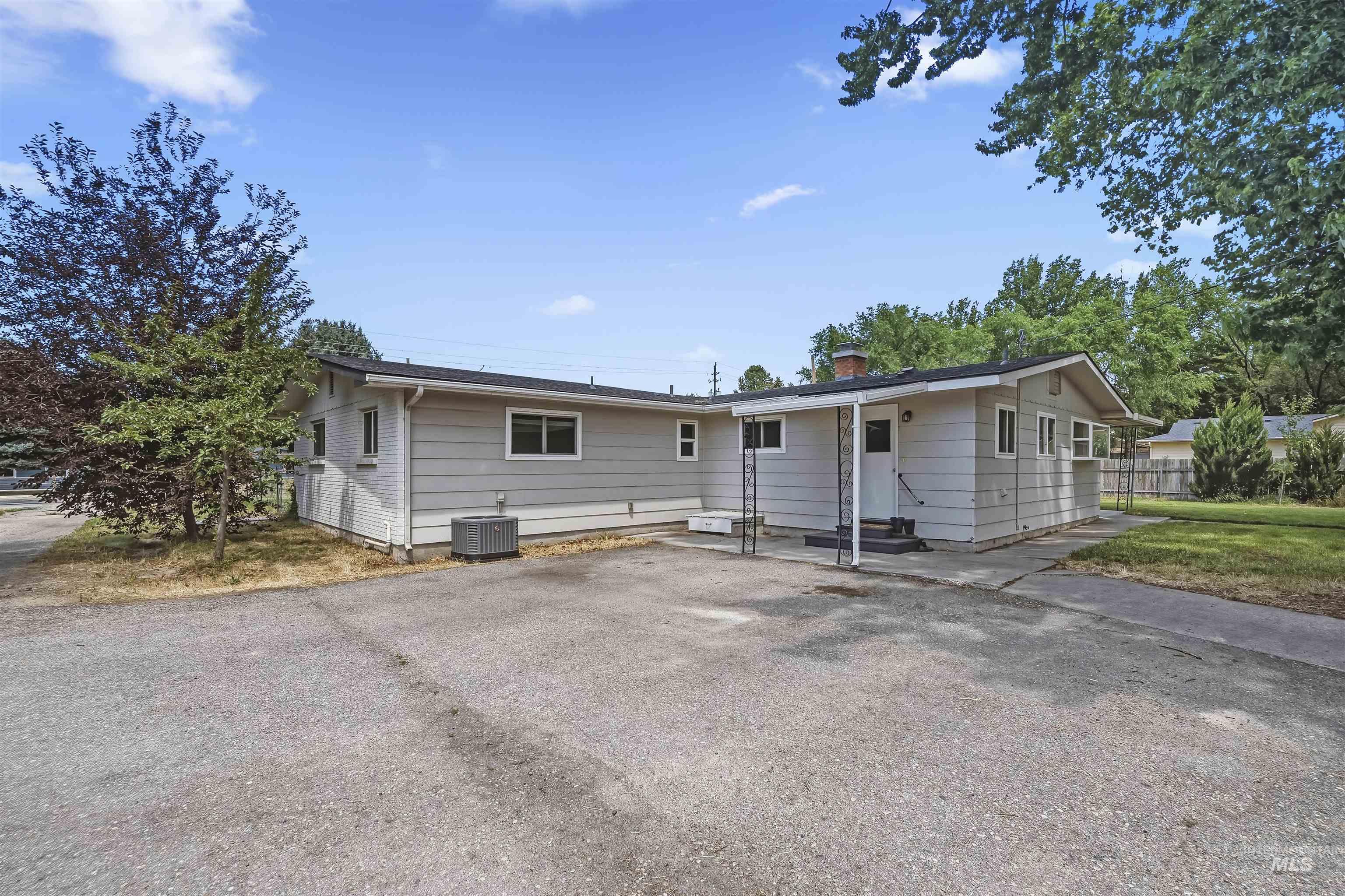 355 East Beacon Light Road Eagle, ID 83616 - Photo 29 of 47 Single-story residence featuring light gray siding, a black shingle roof, and multiple windows