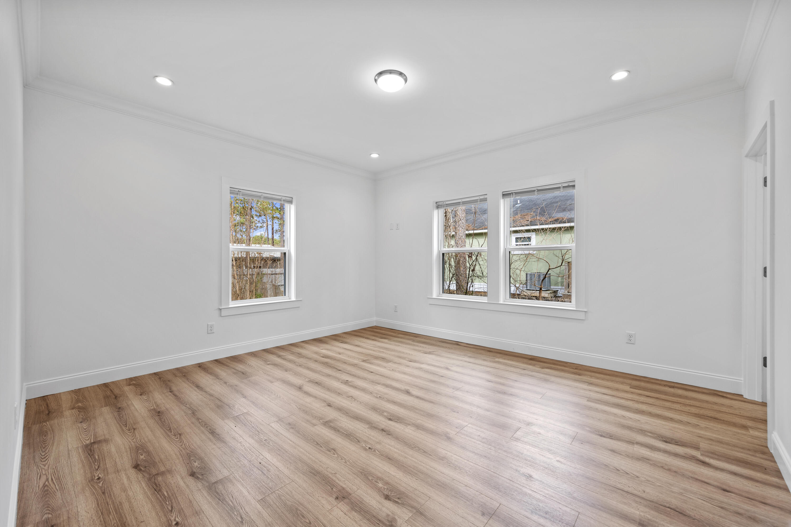 60 4th Street Santa Rosa Beach, FL 32459 - Photo 8 of 22 an empty room with wooden floor and windows