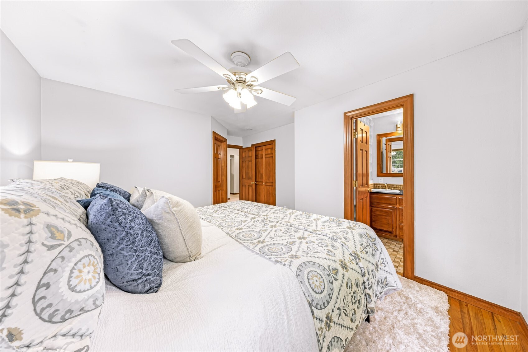 9067 Sunrise Road Custer, WA 98240 - Photo 14 of 40 a bedroom with a large bed and a chandelier