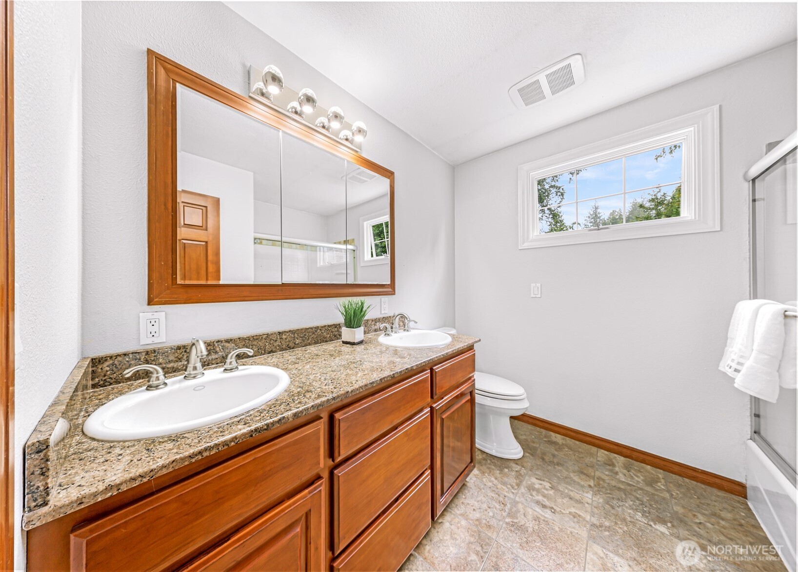 9067 Sunrise Road Custer, WA 98240 - Photo 17 of 40 a bathroom with a granite countertop sink mirror vanity and toilet