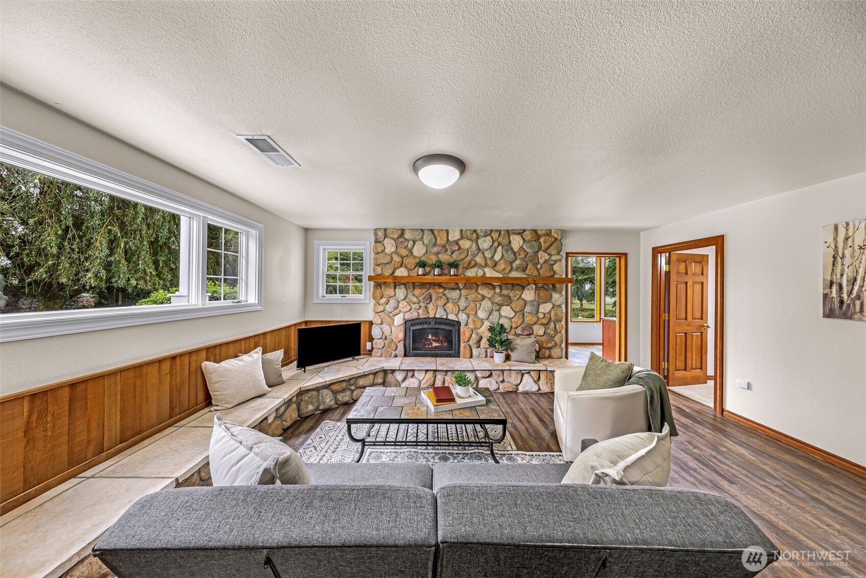 9067 Sunrise Road Custer, WA 98240 - Photo 22 of 40 a living room with furniture a fireplace and a floor to ceiling window
