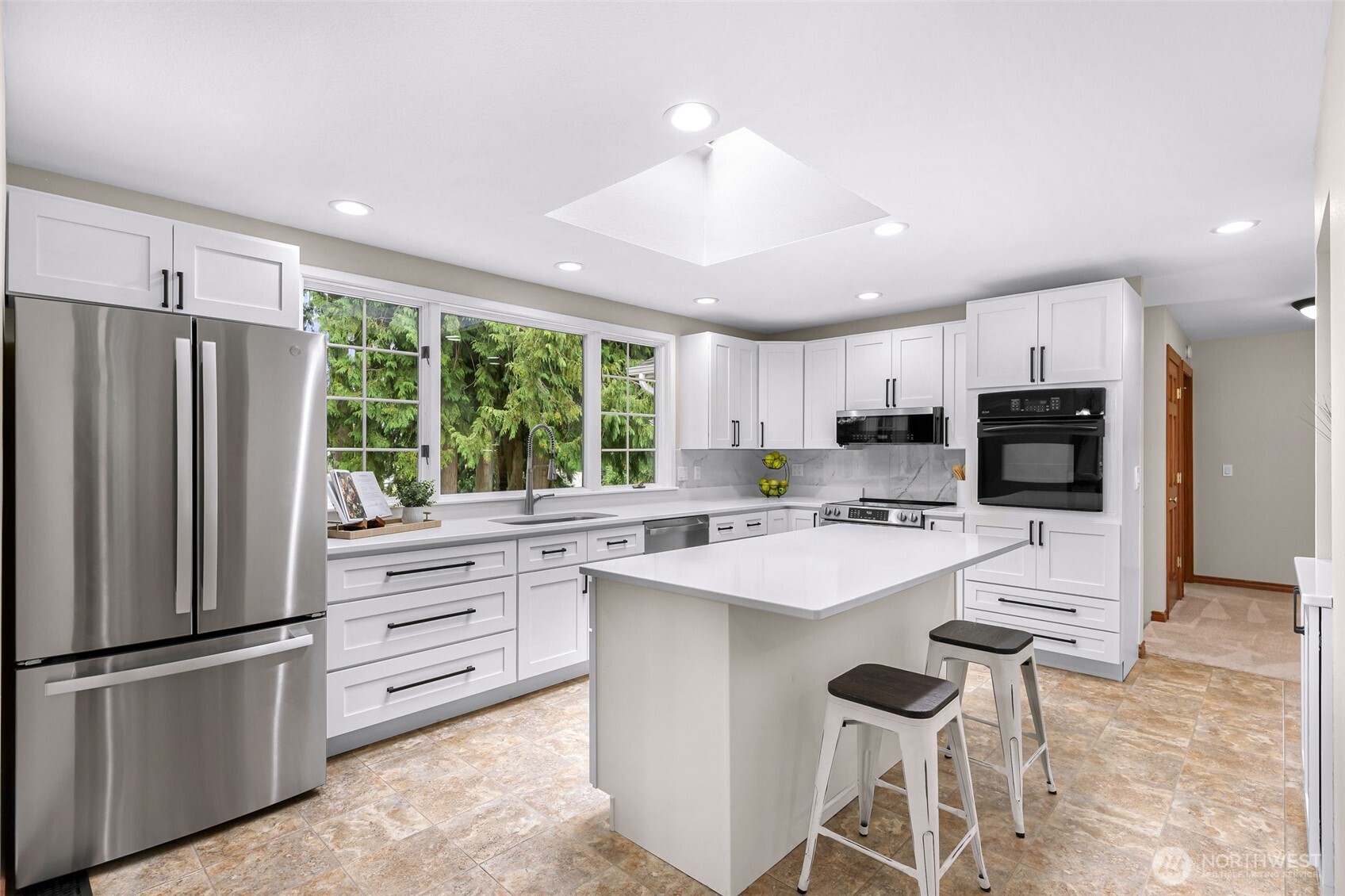 9067 Sunrise Road Custer, WA 98240 - Photo 10 of 40 a kitchen with stainless steel appliances a refrigerator stove microwave and cabinets