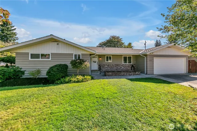 a front view of house with yard and green space