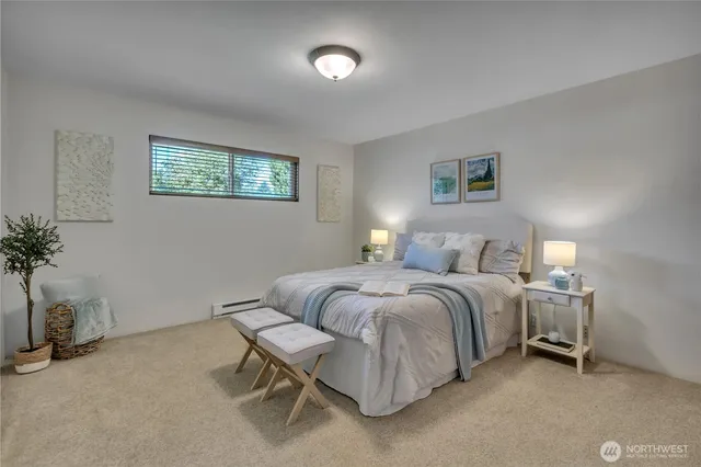 a spacious bedroom with a bed and a potted plant