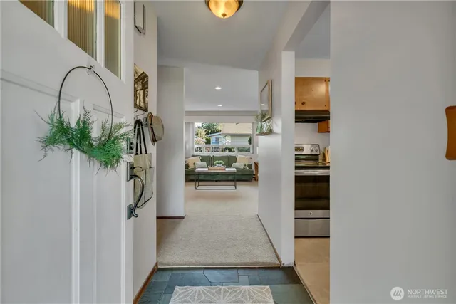 a hallway with a dining table and chairs