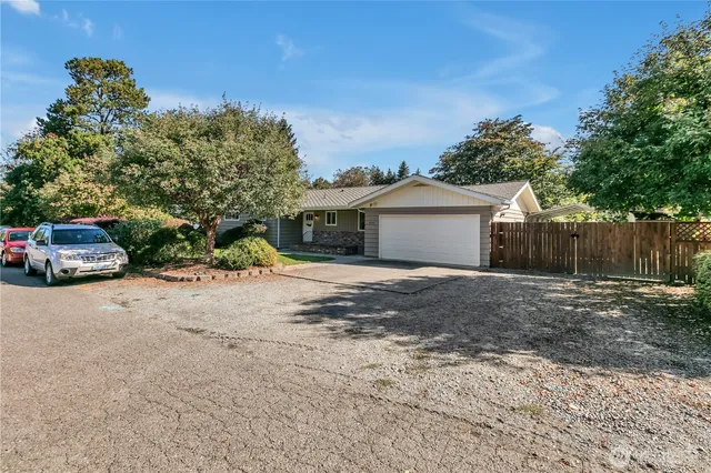 a front view of house with yard and trees around