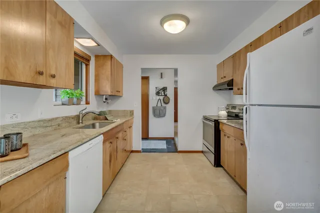 a kitchen with a sink stove and refrigerator