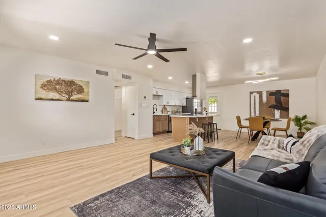 a living room with furniture and kitchen view