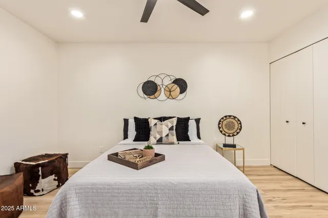 a bedroom with a bed and a chandelier