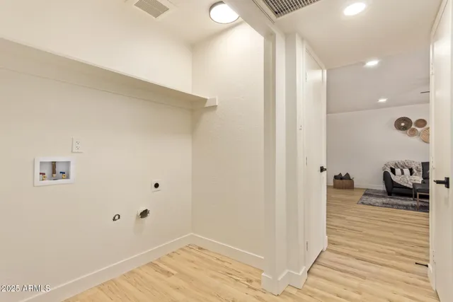 a bedroom with a bed and a wooden floor