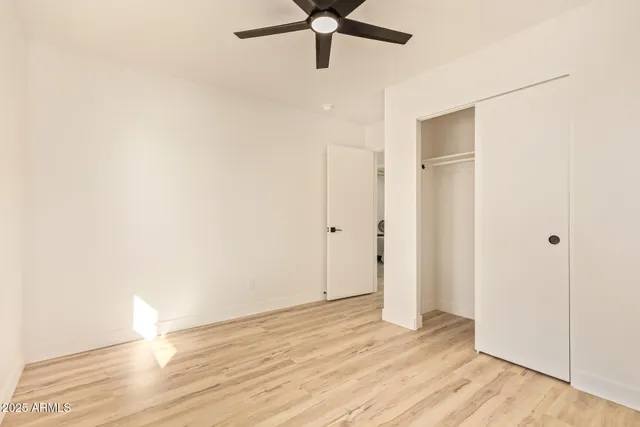 a view of empty room with wooden floor