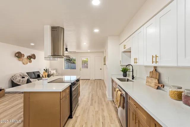 a kitchen with a sink stove and cabinets