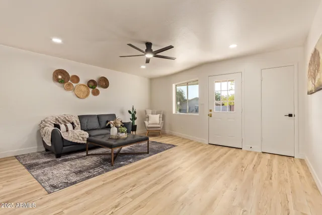 a living room with furniture and wooden floor