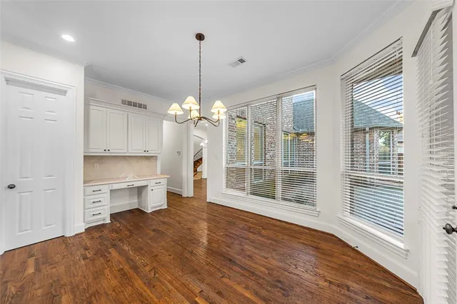 wooden floor fireplace and windows in an empty room