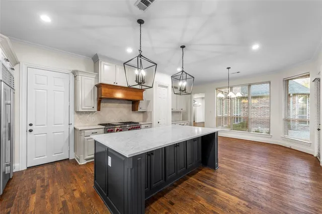 a kitchen with a stove sink and cabinets
