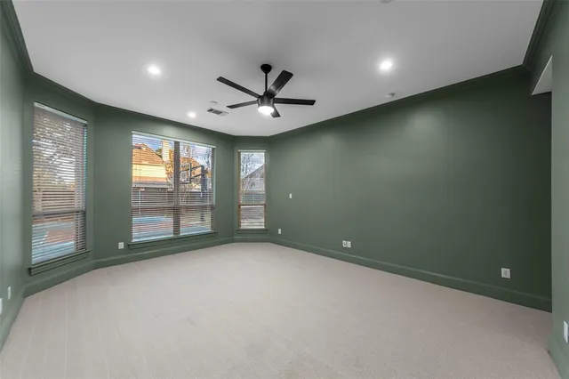 a view of a livingroom with a ceiling fan and window