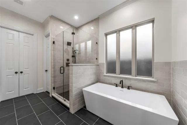 a bathroom with a double vanity sink a large mirror and shower