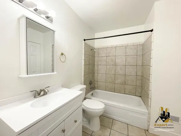 a bathroom with a sink mirror and toilet