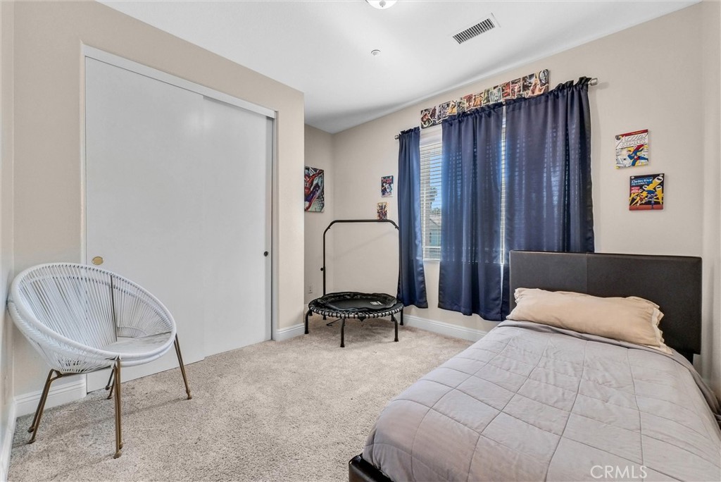 11499 Bridgeway Drive Riverside, CA 92505 - Photo 32 of 70 a bedroom with a bed and a chair