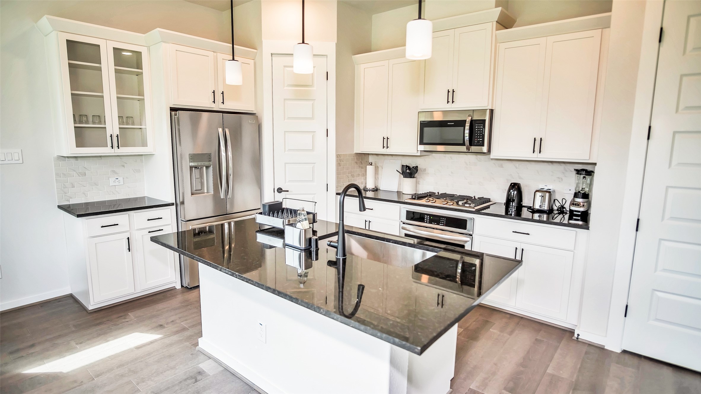 1919 Pueblo Nuevo Path Houston, TX 77077 - Photo 44 of 50 a kitchen with stainless steel appliances granite countertop a sink a stove and a refrigerator