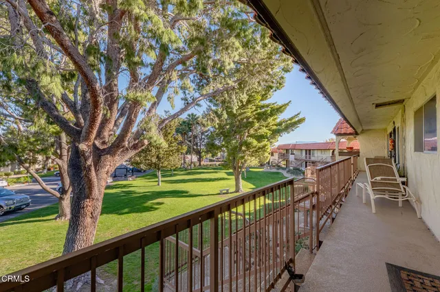 a view of a porch with a yard and furniture