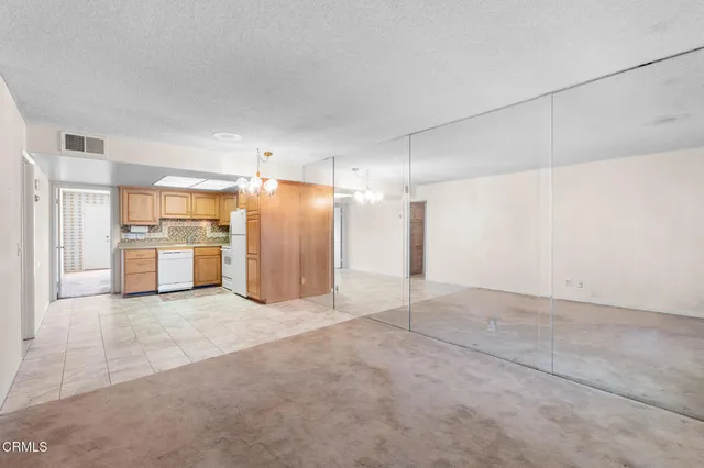a view of a kitchen with a sink and a refrigerator