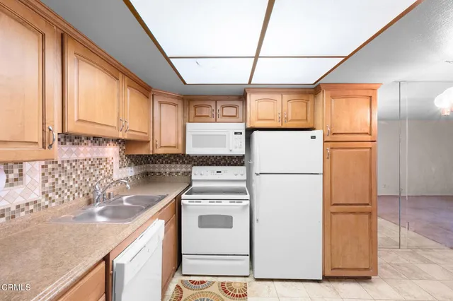 a white refrigerator freezer sitting in a kitchen