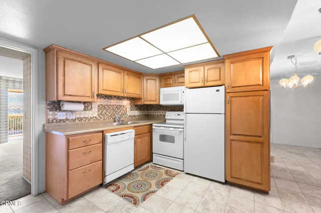 a kitchen with stainless steel appliances granite countertop a refrigerator sink and cabinets