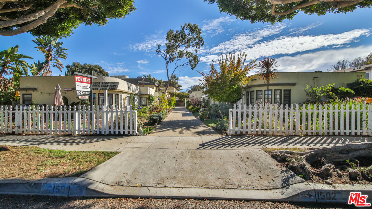 a view of a house with a wooden fence