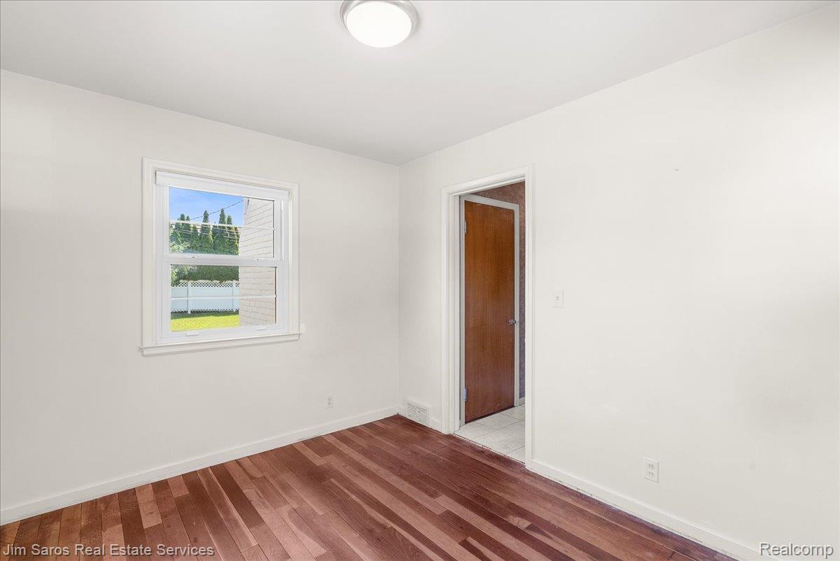 1010 Nottingham Road Grosse Pointe, MI 48230 - Photo 11 of 30 Bright interior room featuring wood-finish flooring, white walls, and a white trim window
